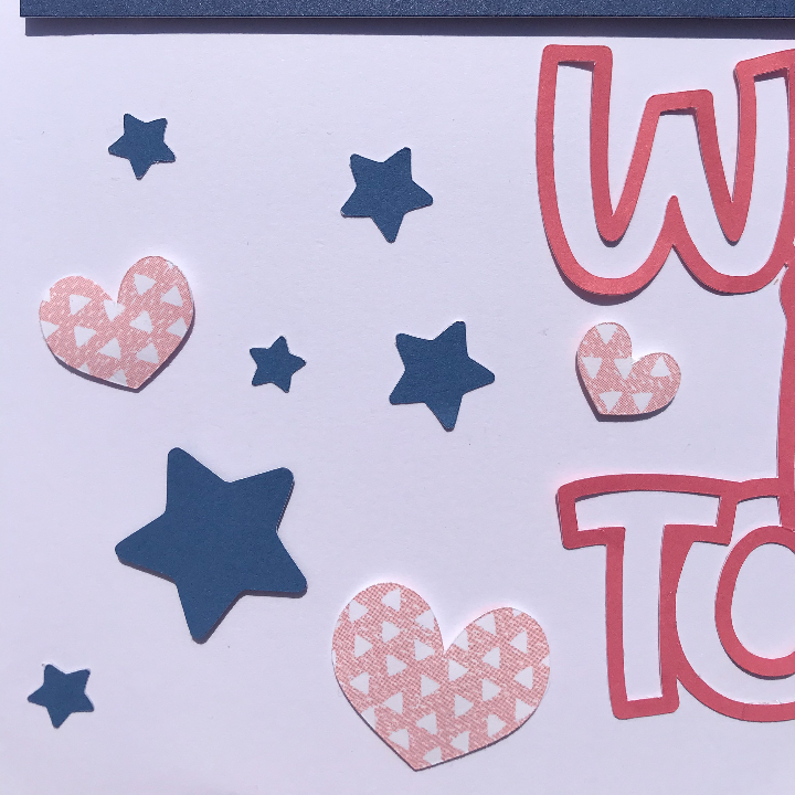 Adding stars and hearts to the family scrapbook page to finish it 