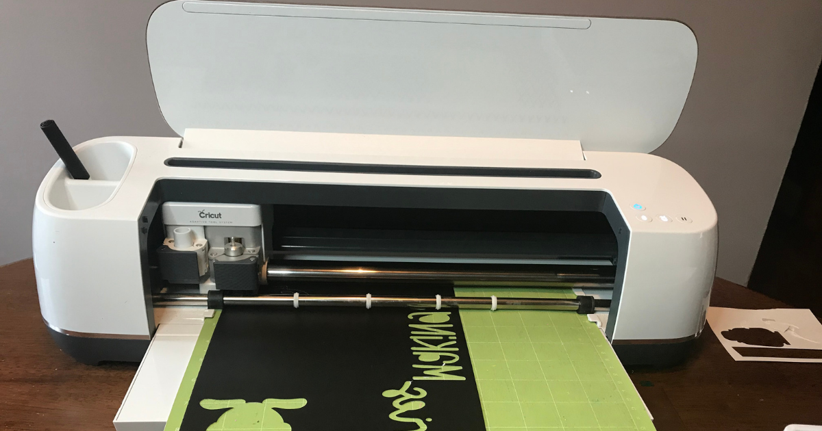 The Cricut Maker cutting the picnic scrapbook layout design in card stock 