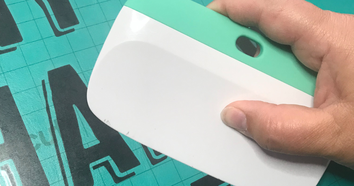press firmly over the vinyl design with the scraper