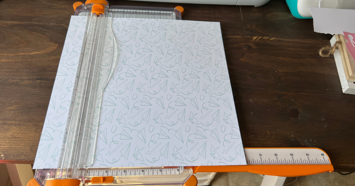 cutting the scrapbook paper to create the last day of school scrapbook page