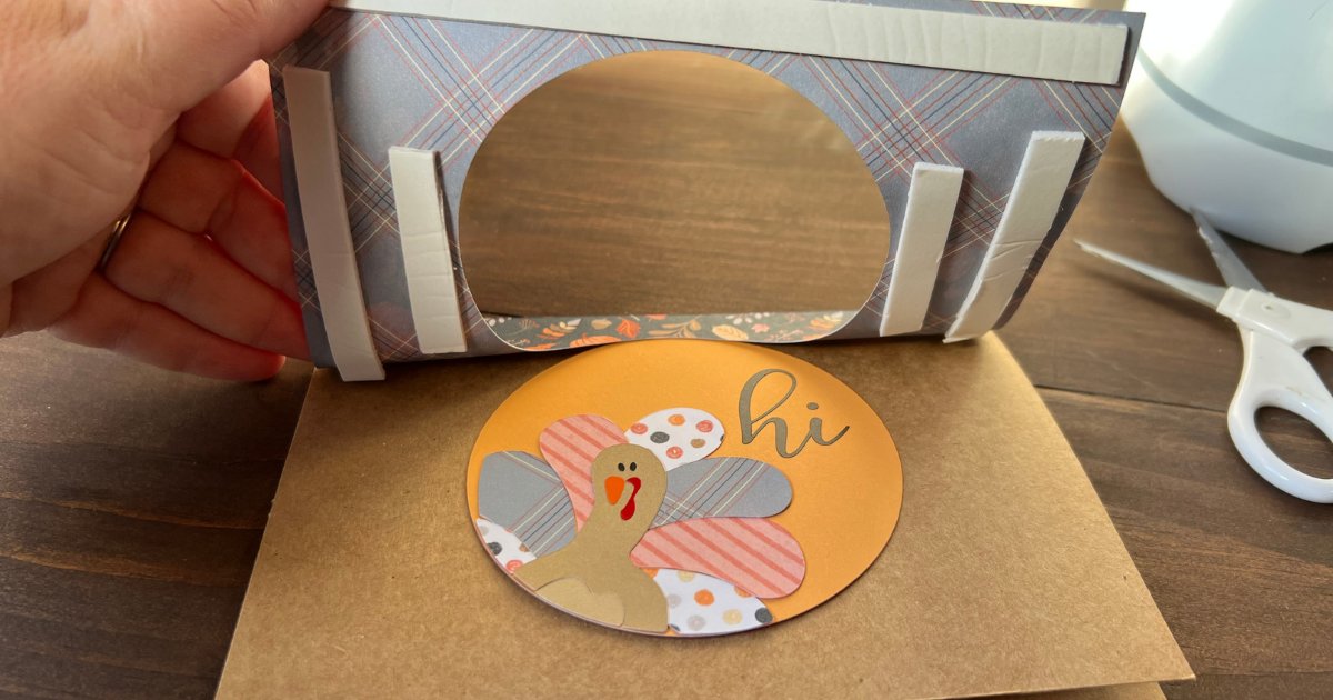 Slide the turkey into the center window and then press the outside of the card around it 